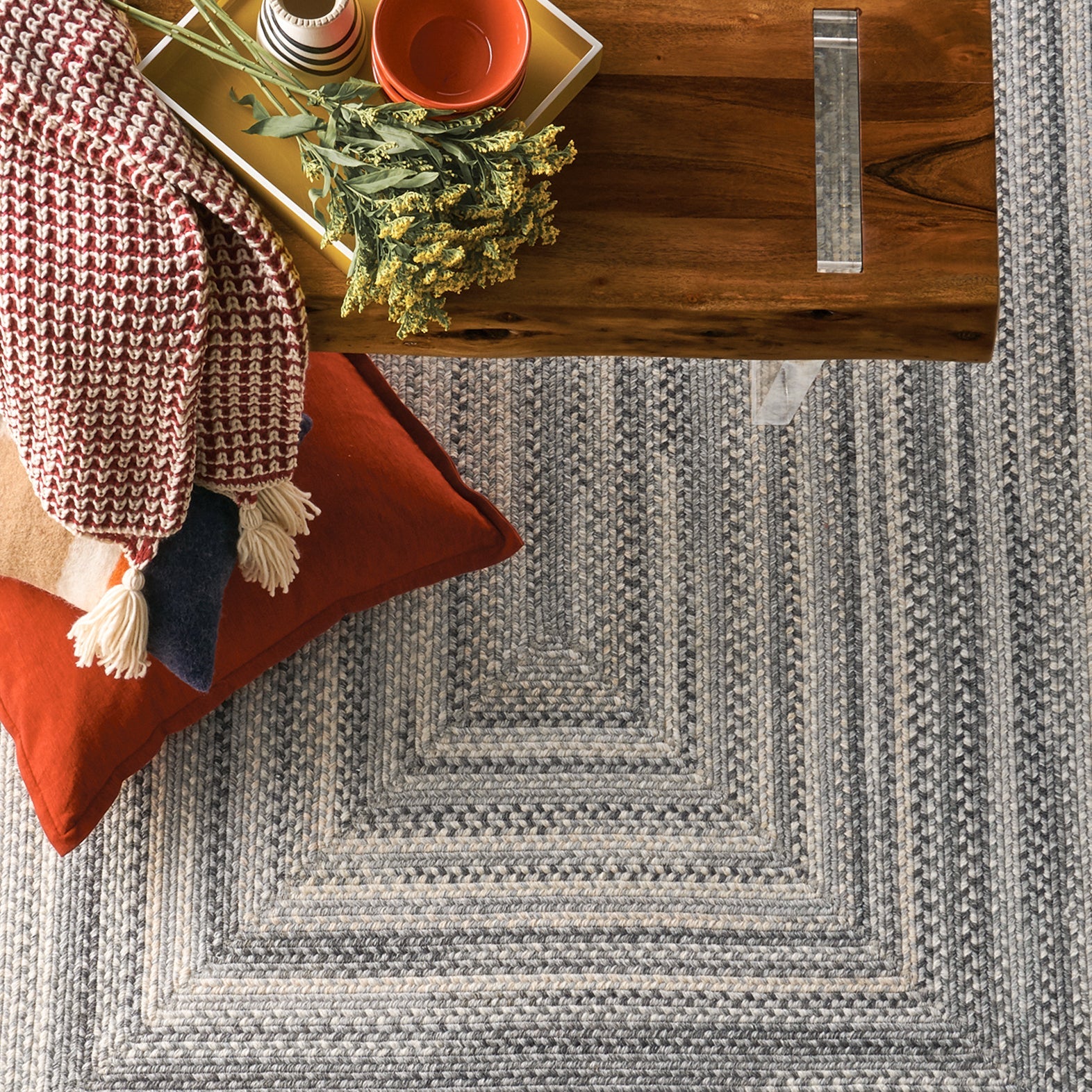 cozy braided rug with bench blanket and pillow