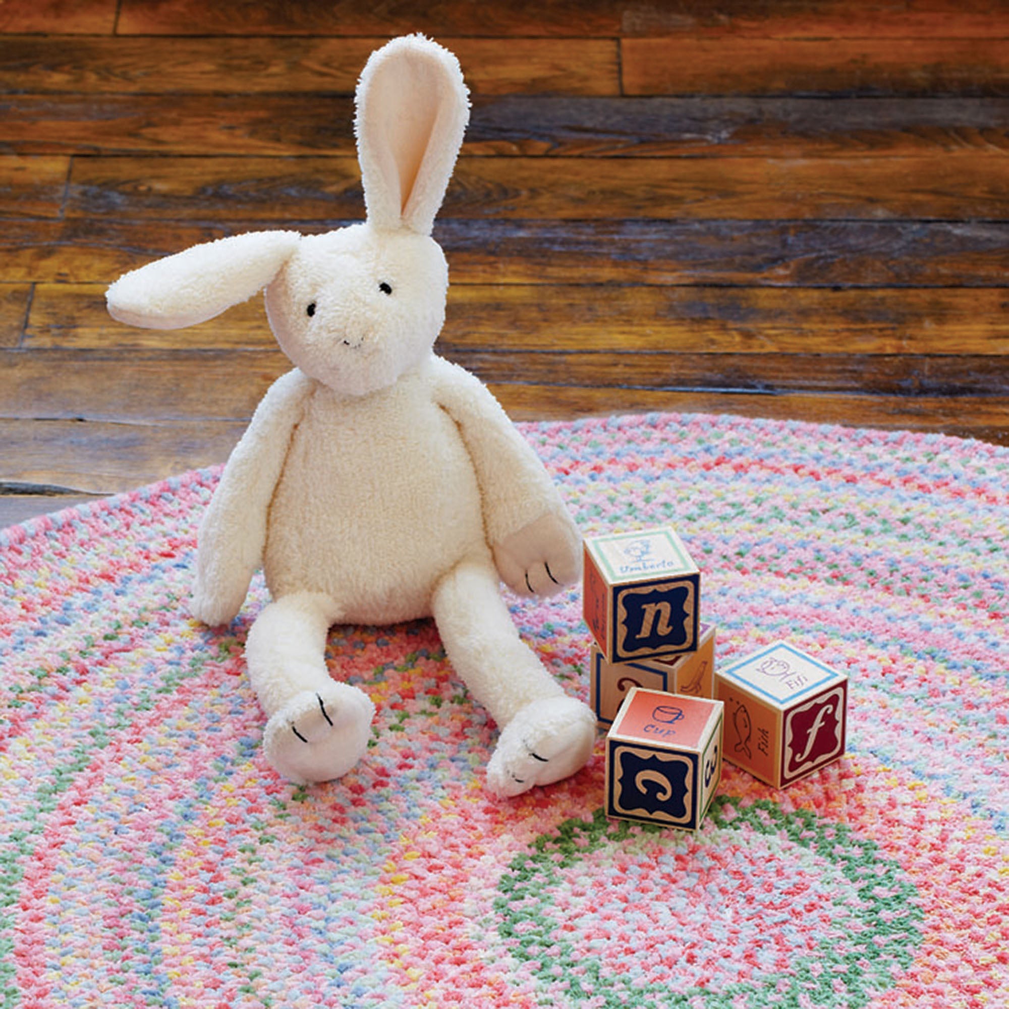 pastel color rug with bunny and blocks